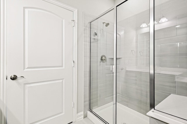 bathroom featuring a shower with shower door