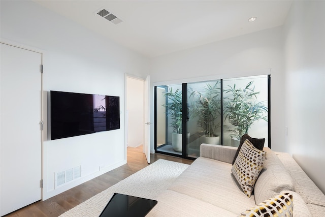 bedroom with access to exterior and hardwood / wood-style flooring