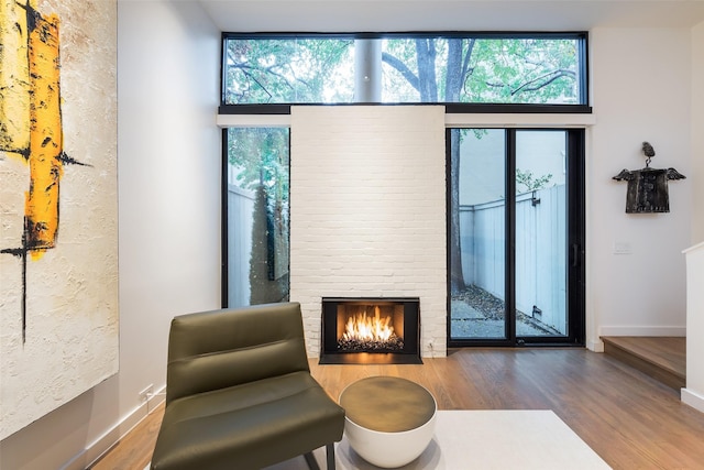 sitting room featuring a fireplace and hardwood / wood-style floors