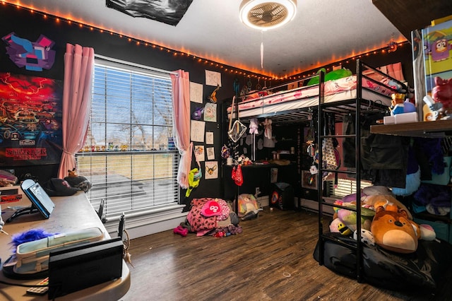 bedroom with wood-type flooring and multiple windows