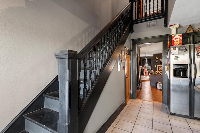 stairs featuring tile patterned flooring