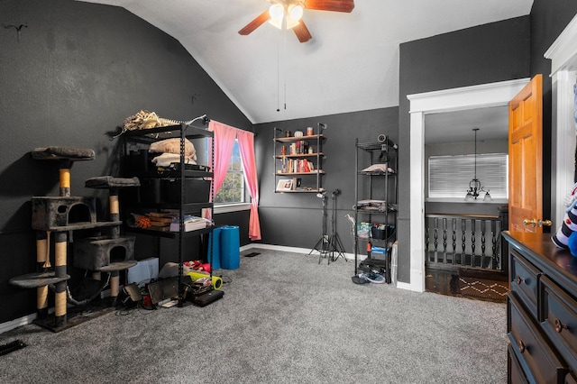 interior space with vaulted ceiling, ceiling fan, and carpet