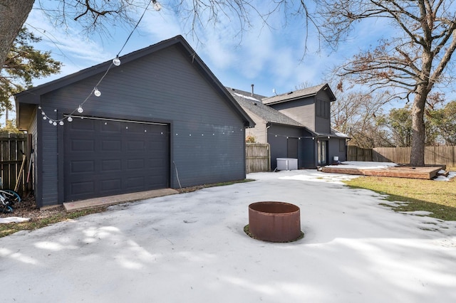 view of side of property with a garage and an outbuilding