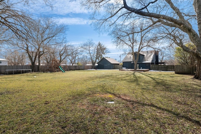 view of yard featuring a playground and a trampoline