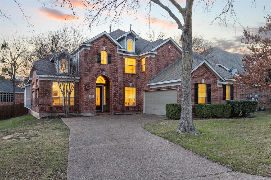 view of front property with a lawn and a garage