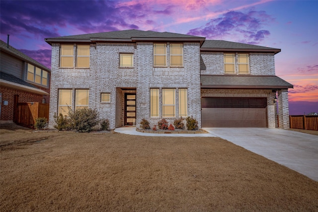 view of front of home with a garage and a lawn