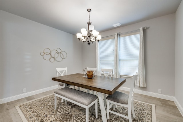 dining area featuring a chandelier and light hardwood / wood-style flooring