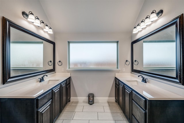 bathroom featuring vanity, vaulted ceiling, and tile patterned floors