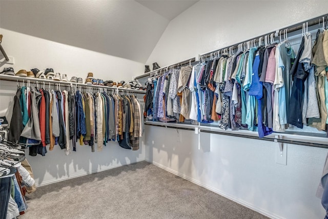 spacious closet featuring lofted ceiling and carpet floors