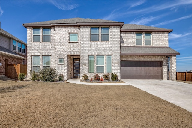 view of front of house featuring a garage and a front lawn