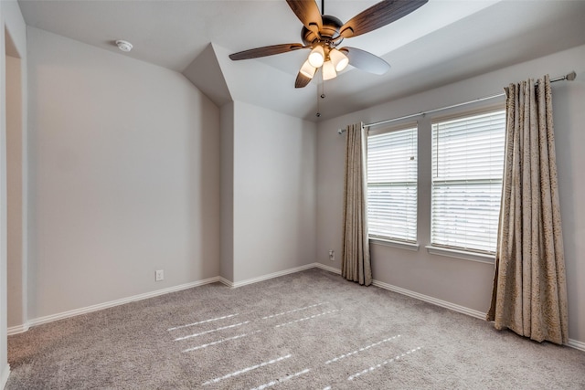 empty room with ceiling fan and light carpet