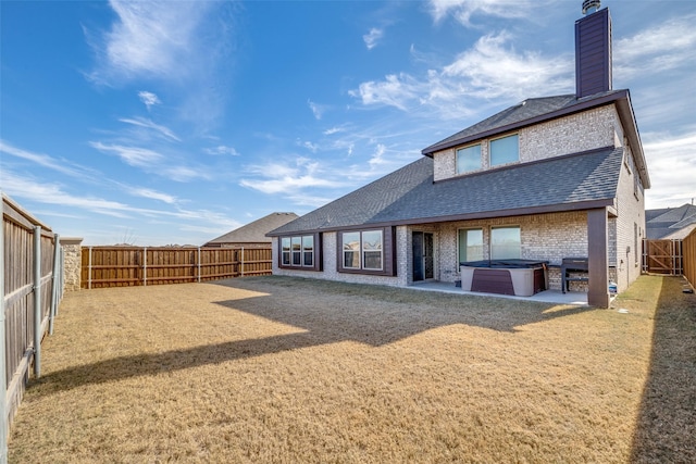 back of property featuring a patio area and a hot tub