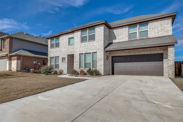 view of front of home with a front lawn and a garage