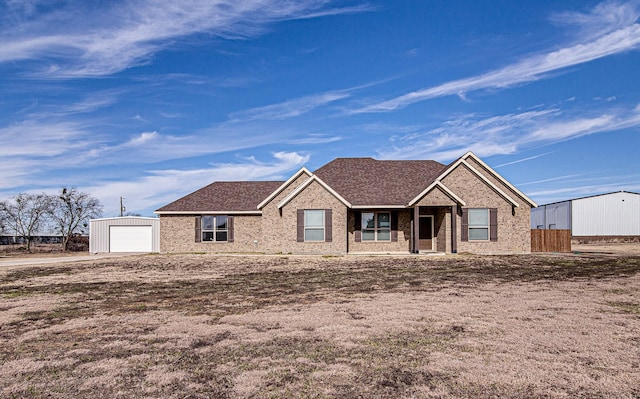 view of front facade with an outbuilding and a garage