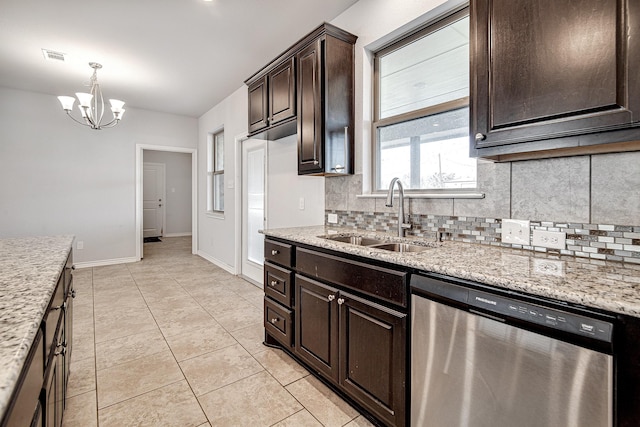 kitchen featuring light stone countertops, stainless steel dishwasher, a notable chandelier, light tile patterned flooring, and sink