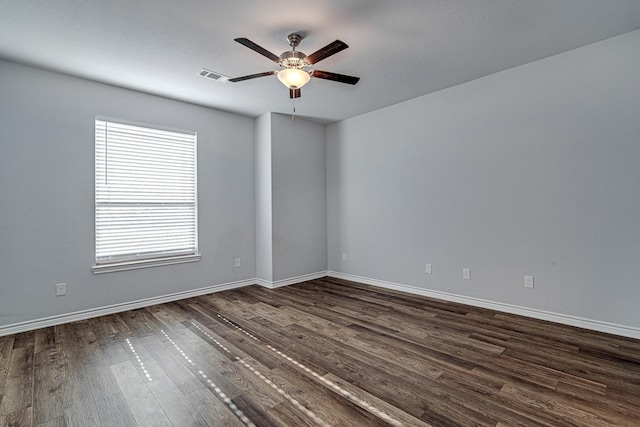 empty room with dark wood-type flooring and ceiling fan