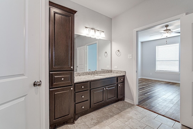 bathroom featuring ceiling fan and vanity