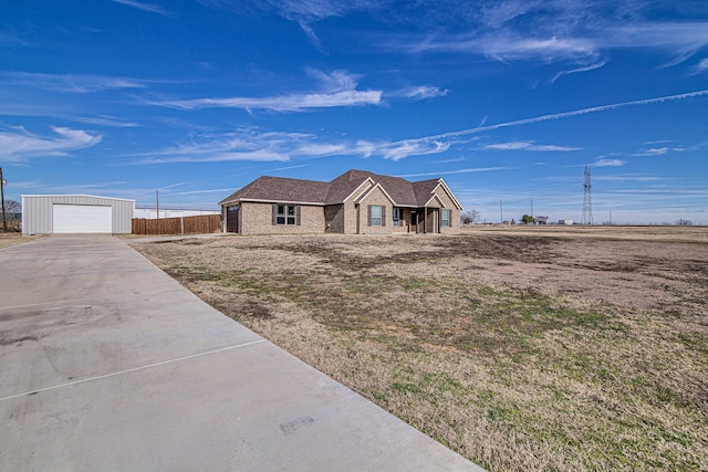 view of front of house with a garage and an outdoor structure