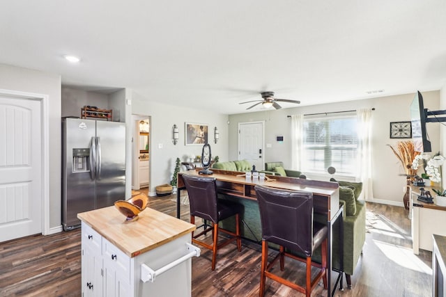 kitchen featuring stainless steel fridge with ice dispenser, dark hardwood / wood-style flooring, and white cabinetry