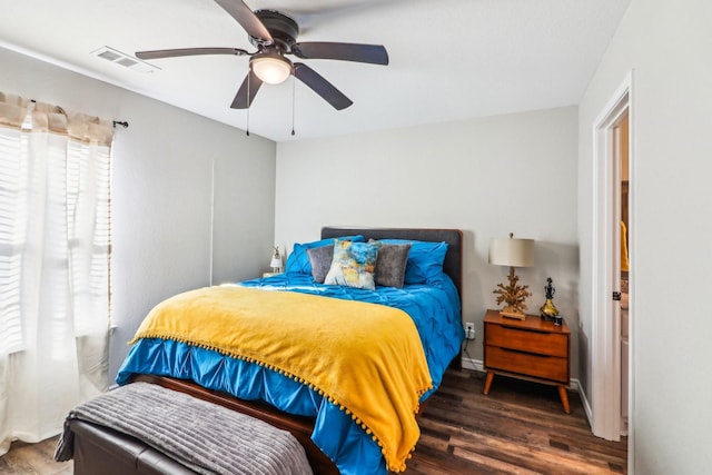 bedroom with ceiling fan and dark hardwood / wood-style floors