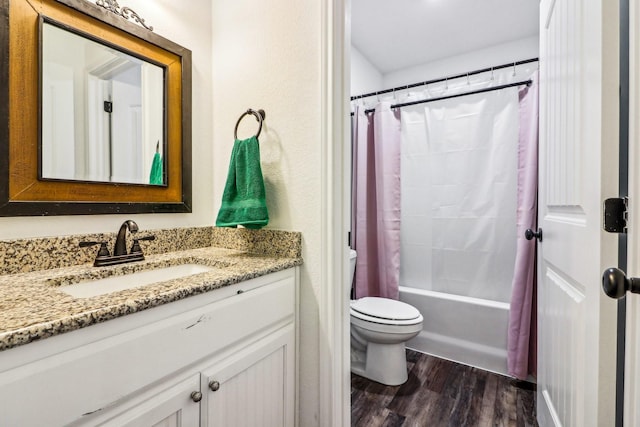 full bathroom featuring toilet, shower / bathtub combination with curtain, vanity, and hardwood / wood-style floors