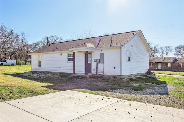 rear view of property with a yard