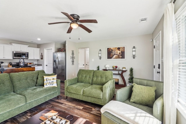 living room with ceiling fan and dark hardwood / wood-style floors