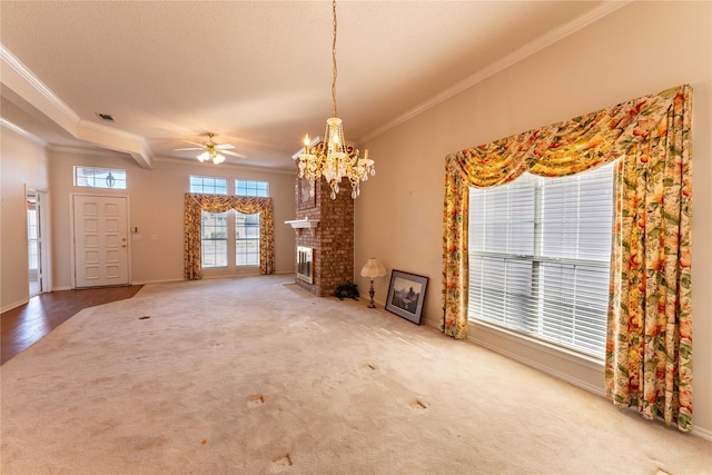 unfurnished living room with a textured ceiling, crown molding, ceiling fan with notable chandelier, and carpet flooring