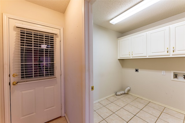 clothes washing area with a textured ceiling, washer hookup, cabinets, hookup for an electric dryer, and light tile patterned flooring