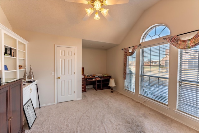 interior space with ceiling fan, light carpet, and lofted ceiling