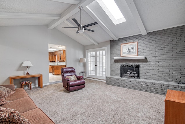 living room with a textured ceiling, ceiling fan, carpet flooring, and a fireplace