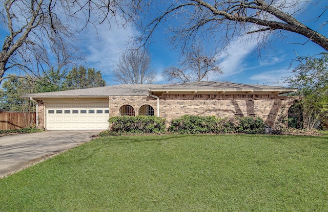 single story home featuring a garage and a front lawn