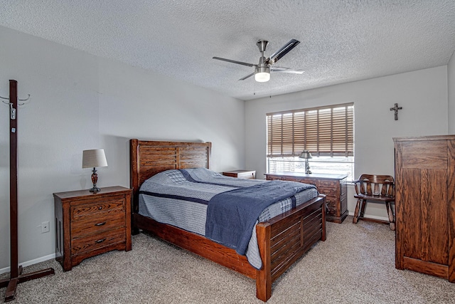 carpeted bedroom with ceiling fan and a textured ceiling