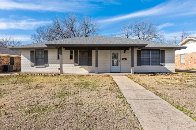 ranch-style house featuring cooling unit and a front lawn