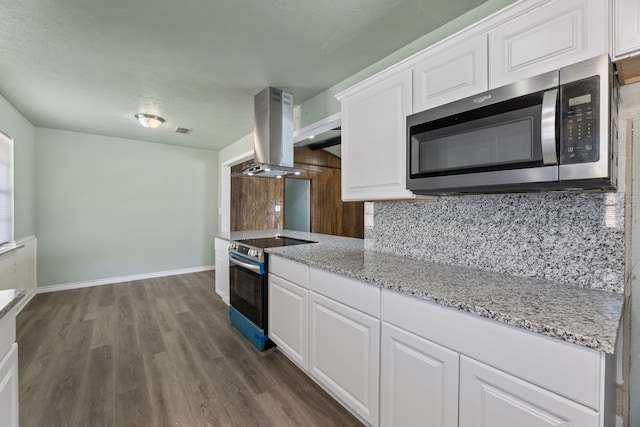 kitchen with stainless steel appliances, white cabinets, island exhaust hood, backsplash, and dark hardwood / wood-style flooring