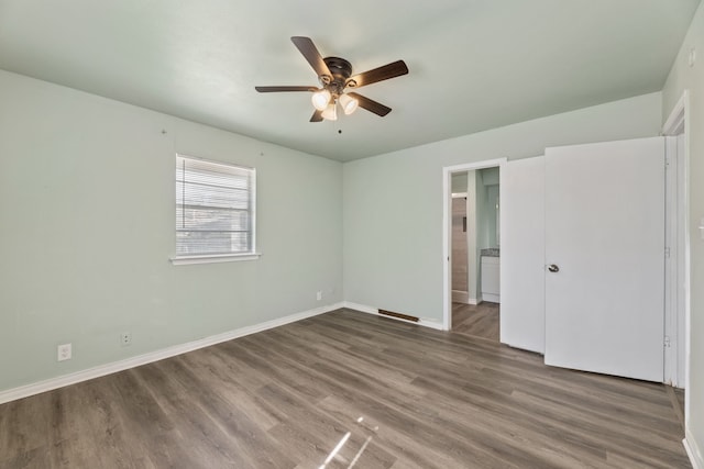 unfurnished bedroom featuring hardwood / wood-style floors and ceiling fan