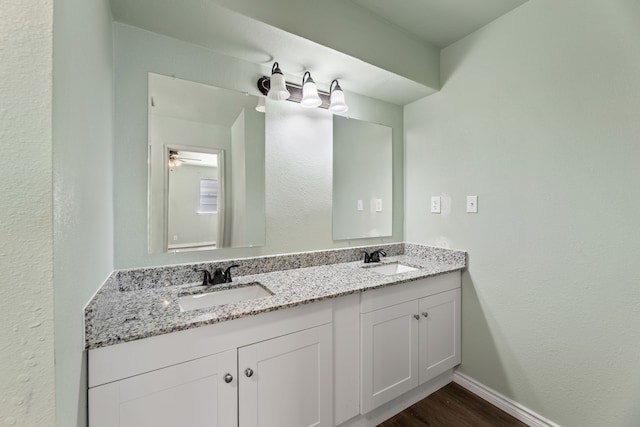 bathroom with vanity, ceiling fan, and hardwood / wood-style flooring