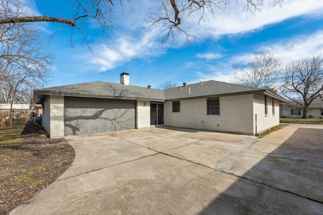 rear view of property with a garage