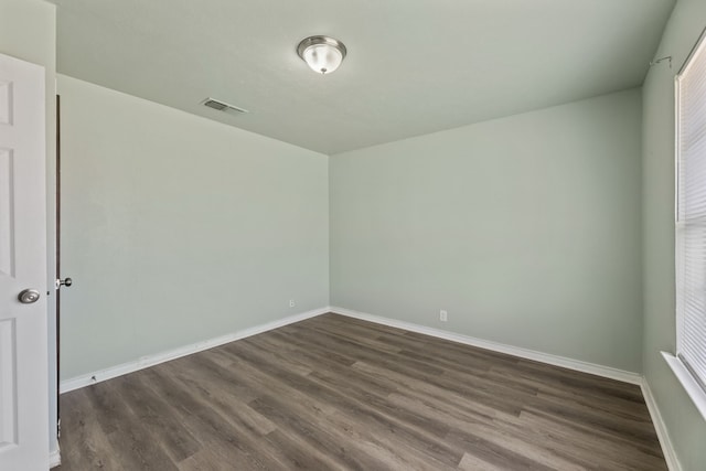 spare room with dark wood-type flooring