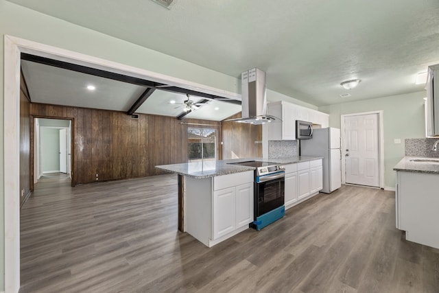 kitchen with kitchen peninsula, island range hood, decorative backsplash, white cabinets, and appliances with stainless steel finishes