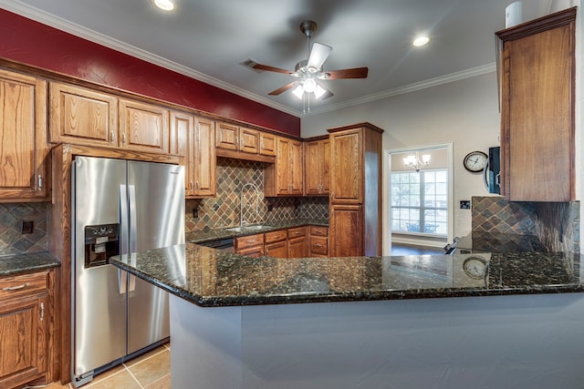 kitchen with sink, crown molding, kitchen peninsula, and stainless steel fridge