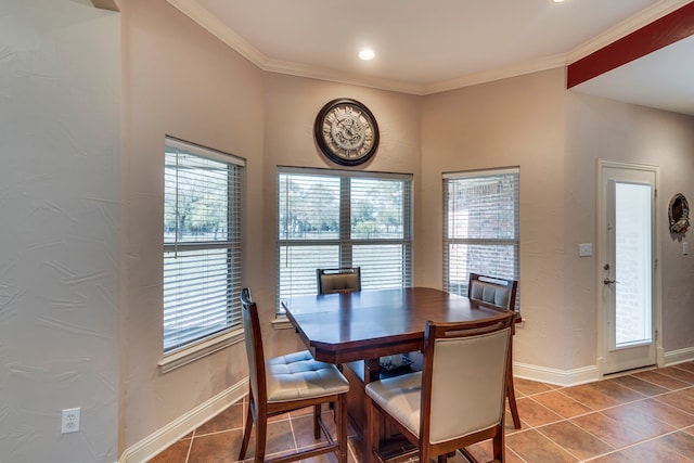 tiled dining area with baseboards and ornamental molding