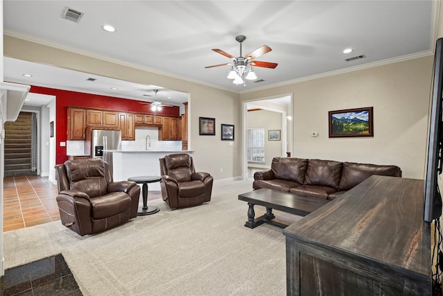 living area featuring stairs, visible vents, crown molding, and recessed lighting