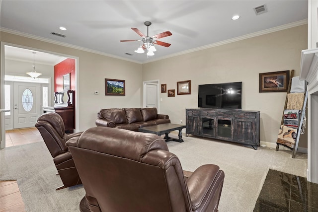 living room featuring visible vents, crown molding, light carpet, and baseboards