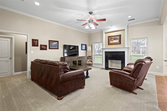 living area with baseboards, visible vents, crown molding, and a tile fireplace