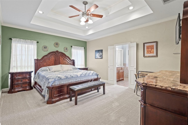 bedroom featuring multiple windows, a raised ceiling, and light colored carpet