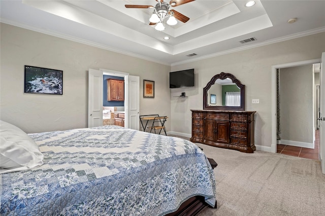 bedroom with carpet, visible vents, a raised ceiling, and baseboards