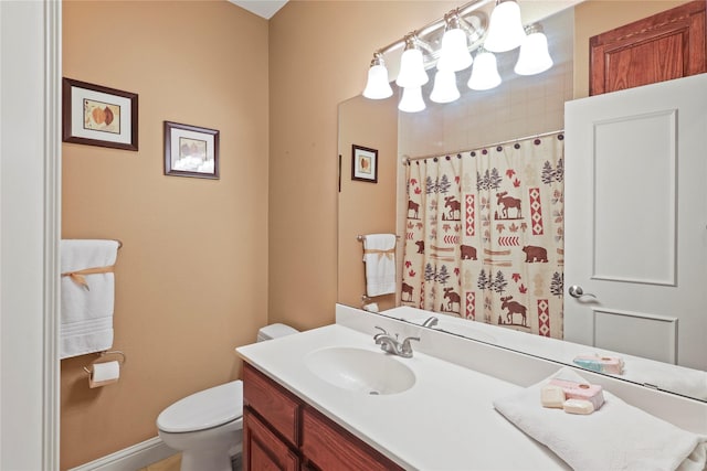 bathroom with toilet, vanity, and a shower with curtain