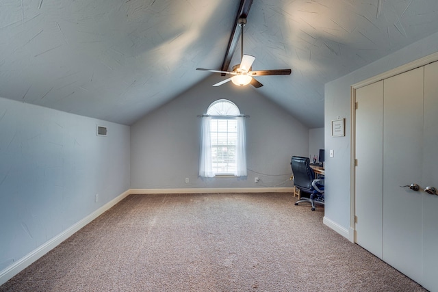 unfurnished office featuring carpet floors, ceiling fan, and vaulted ceiling