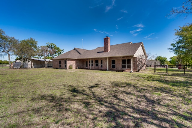 back of property with a lawn